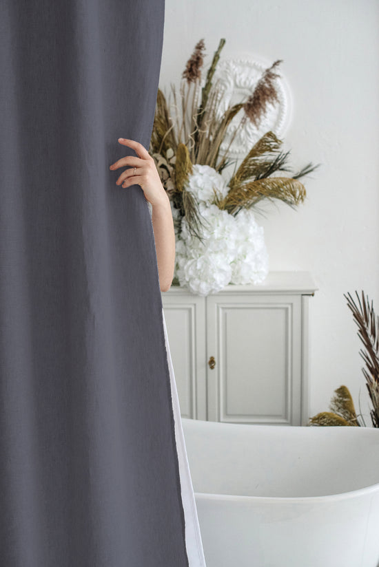 a woman peeking out from behind a curtain